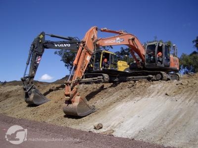 GPS diggers working side-by-side to bulk and trim a cut batter.