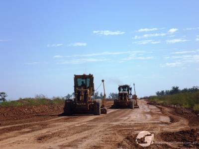 One grader bulks using GPS while the other trims using total station guidance.